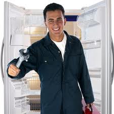 Essential Appliance, Inc.- Repairman working on a Fridge